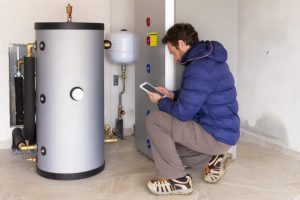 Plumber repairing water heater