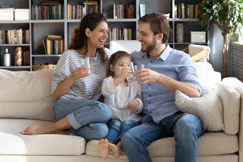 family holding water glasses